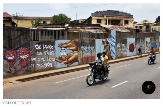 In Conakry, Guinea, a whole street is lined with Covid-19 images, showing hand sanitisers, washing hands, wearing masks.