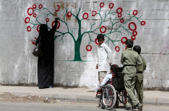 Murad Subay, Yemen 'Colour your streets'. Woman painting a tree.