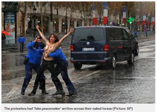 A topless FEMEN protester who tried to intercept President Trump's car on its way to the Armistice Day celebration in PAris, November 11, 2018