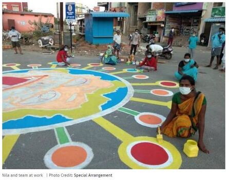 Tamil Nadu trans women painting a very large image of a coronavirus on the pavement in the town of Pallikaranai.